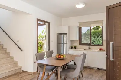 a kitchen and dining room with a table and chairs at Ionion H30 in Ayia Napa