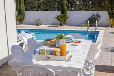 a white table with a tray of food and drinks at Ionion H30 in Ayia Napa