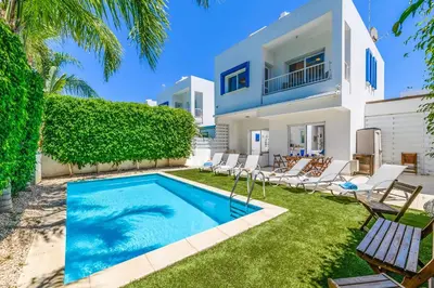 a villa with a swimming pool and a house at Villa Atlantis in Protaras