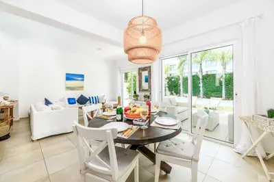 a dining room and living room with a table and chairs at Villa Atlantis in Protaras