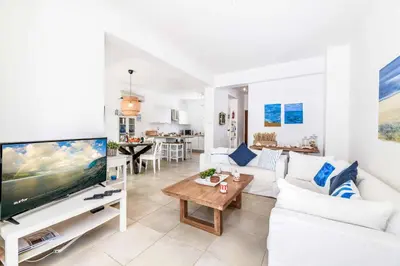 a living room with a large tv and a couch at Villa Atlantis in Protaras