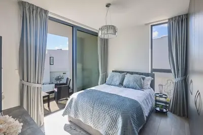a bedroom with a bed and a view of a table at Villa Almaria ALM28 in Protaras