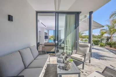 a living room with a couch and a table at Villa Almaria ALM28 in Protaras