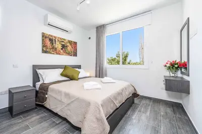 a bedroom with a bed and a window at Green Bay Villa 15 in Protaras
