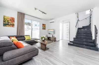 a living room with a couch and a table at Green Bay Villa 15 in Protaras
