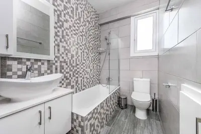 a white bathroom with a sink and a toilet at Green Bay Villa 15 in Protaras