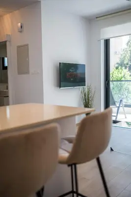 a kitchen with a table and two chairs and a window at CasaMar - Upscale One-Bedroom Apartment by the Sea in Larnaka