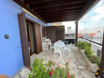 a patio with a table and chairs on a balcony at Αετοφωλιά-AETOFOLIA in Pano Lefkara