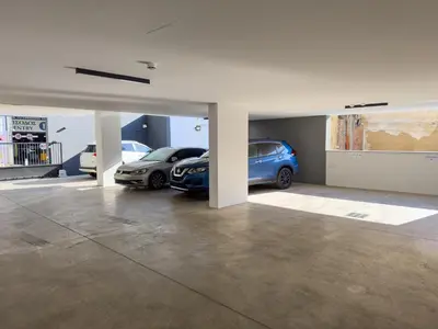 a garage with two cars parked in it at SWIFT Suites Limassol in Limassol