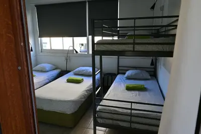 two bunk beds in a room with a window at Lemongrass Hostel in Limassol