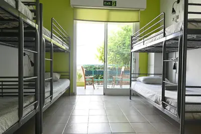 a room with bunk beds and a patio at Lemongrass Hostel in Limassol