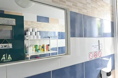 a mirror in a bathroom with blue and white tiles at Lemongrass Hostel in Limassol