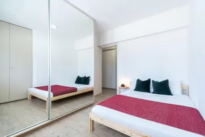 a bedroom with a mirror and a bed at Sunny & Stylish City Centre Living in Nicosia