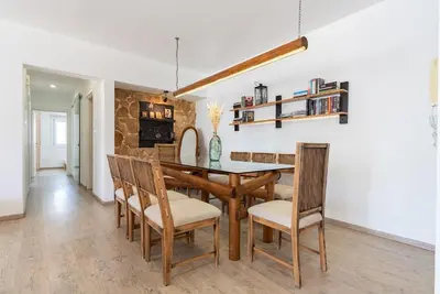 a dining room with a wooden table and chairs at Sunny & Stylish City Centre Living in Nicosia