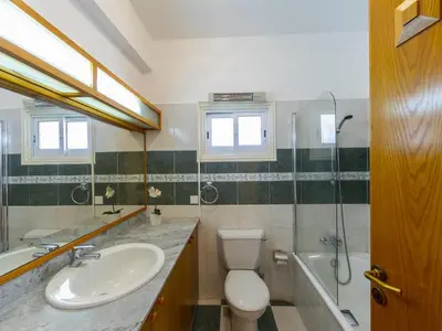 a bathroom with a sink and a toilet and a shower at Pervolia Nirides Seaside Mansion 7 in Larnaka