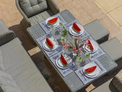 a table with plates of food and watermelon on it at Pervolia Nirides Seaside Mansion 7 in Larnaka
