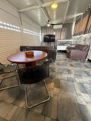 a room with a table and chairs and a couch at Costas court in Limassol