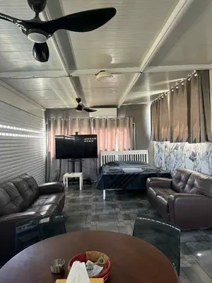 a living room with leather couches and a flat screen tv at Costas court in Limassol