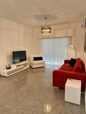 a living room with a couch and a flat screen tv at Charming 2 Bdr Nicosia Apt Free Parking & Wi-Fi in Nicosia