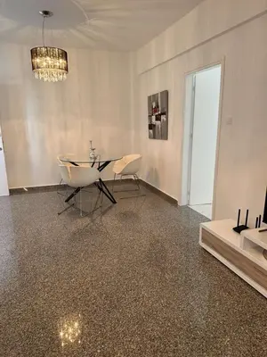 a dining room with a table and chairs and a chandelier at Charming 2 Bdr Nicosia Apt Free Parking & Wi-Fi in Nicosia