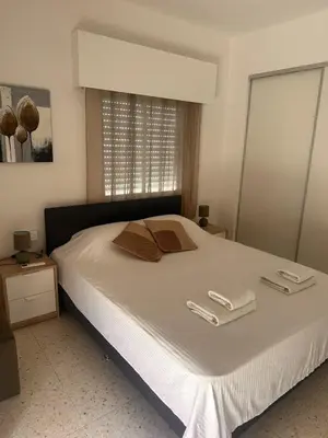 a bedroom with a bed with two towels on it at Charming 2 Bdr Nicosia Apt Free Parking & Wi-Fi in Nicosia