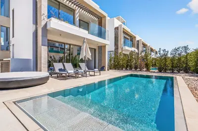 a swimming pool in front of a house at Azure Sama Villa in Protaras