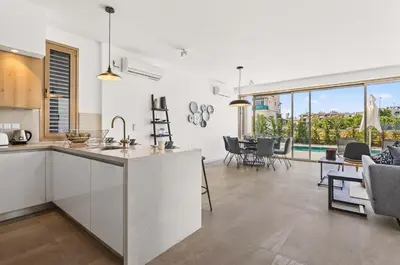 a kitchen and dining room with a view of a living room at Azure Sama Villa in Protaras