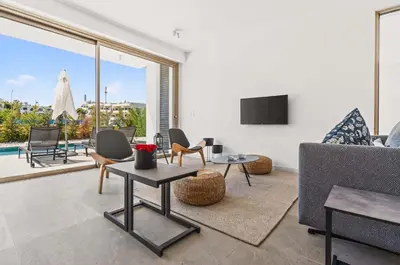 a living room with a couch and a tv at Azure Sama Villa in Protaras