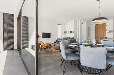 a dining room and living room with a table and chairs at Azure Sama Villa in Protaras