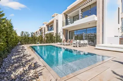 a swimming pool in the backyard of a house at Azure Leda Villa in Protaras