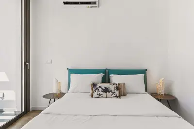 a bedroom with a large bed with white sheets and pillows at Azure Leda Villa in Protaras