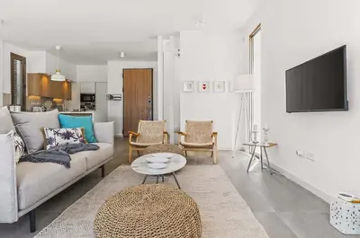 a living room with a couch and a table at Azure Leda Villa in Protaras