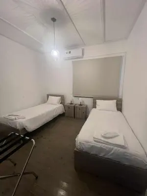 a room with two beds in a room with a projector at Kalidoniahouses in Perapedhi
