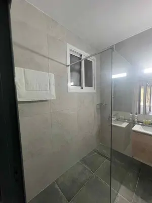 a bathroom with a shower and a sink at Kalidoniahouses in Perapedhi