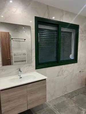 a bathroom with a white sink and a window at Kalidoniahouses in Perapedhi