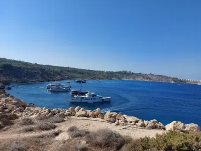 a group of boats docked in a body of water at Andrea's house in Liopetri