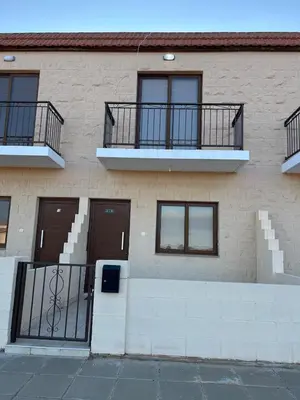 a building with two balconies on the side of it at Andrea's house in Liopetri