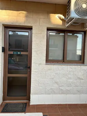 a front door of a house with a fan at Andrea's house in Liopetri