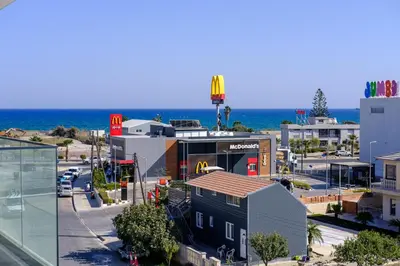 a view of a city with the ocean in the background at Artemis 302 - Seaside Stories in Livadhia