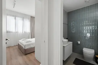a bathroom with a bed and a toilet and a sink at Artemis 302 - Seaside Stories in Livadhia