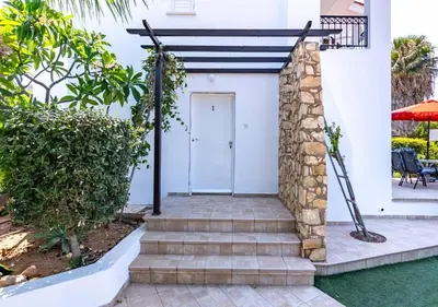 a white house with a white door and stairs at Anemone Seaview Villa DPS01 in Protaras