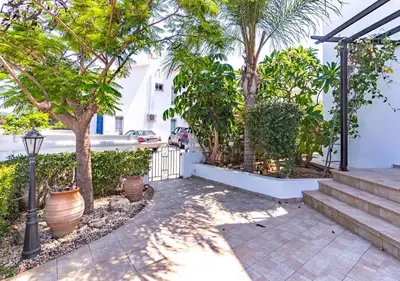 a courtyard with trees and stairs in a house at Anemone Seaview Villa DPS01 in Protaras