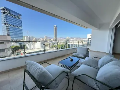 a balcony with chairs and a couch and a large window at Home in Central Nicosia - Spacious Balcony in Nicosia