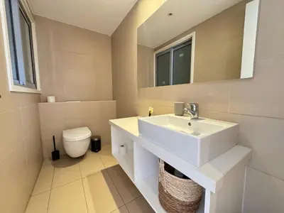 a bathroom with a white sink and a toilet at Home in Central Nicosia - Spacious Balcony in Nicosia