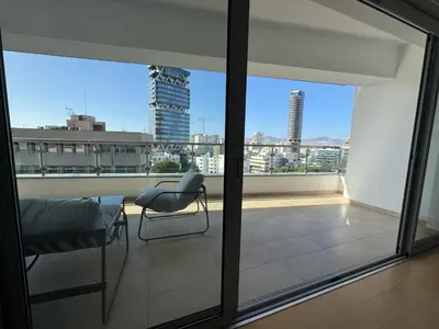 a balcony with a chair and a view of the city at Home in Central Nicosia - Spacious Balcony in Nicosia