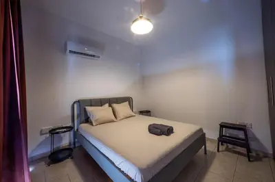 a bedroom with a bed with a towel on it at Penthouse, City Center, Walking to Beach in Larnaka