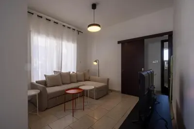 a living room with a couch and a table at Penthouse, City Center, Walking to Beach in Larnaka