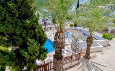 an aerial view of a resort with palm trees and a pool at D&D Apartment in Paralimni