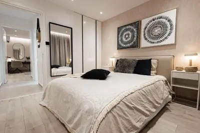 a bedroom with a large bed and a bathroom at Luxury Marina Beach Stay in Limassol