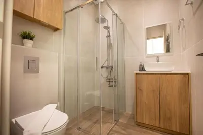 a bathroom with a shower and a toilet and a sink at Irinis 150 Urban Luxury Studios in Limassol